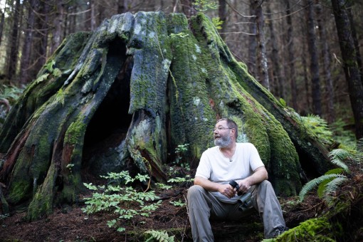 Conservation Biologist Andrew Bryant beside a massive cedar stump amongst second-growth in the Eldred Valley.