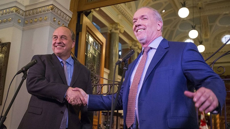B.C. Green Party Leader Andrew Weaver and B.C. NDP Leader John Horgan shaking hands on May 29-2017