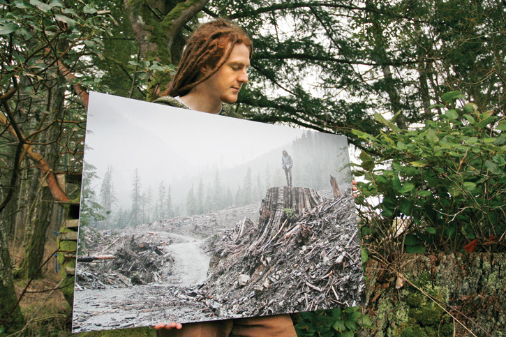 AFA photographer TJ Watt shows a print of his photo of a man on a stump in the Gordon River valley that won first place in a Outdoor Photography Canada magazine photo contest.