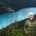 Issy stands on a mountain with Peyto Lake in the background behind her.