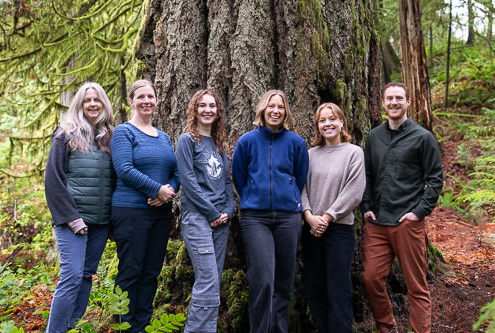 The six AFA team members stand beside each other in front of an old-growth Douglas-fir tree.
