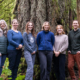 The six AFA team members stand beside each other in front of an old-growth Douglas-fir tree.